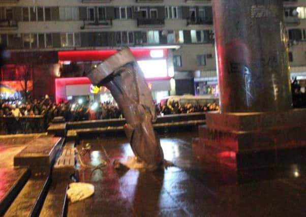 The statue of Soviet hero Lenin in Kiev was toppled and attacked by hammer-wielding protesters yesterday. Picture: AFP/Getty