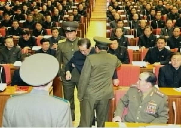 In an image shown on North Korean TV, Jang Song Thaeke is hustled out of the conference hall. Picture: Reuters
