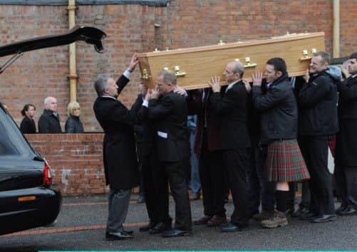 The body of helicopter crash victim Mark O'Prey is carried from St Brides RC Church in East Kilbride. Picture: Getty