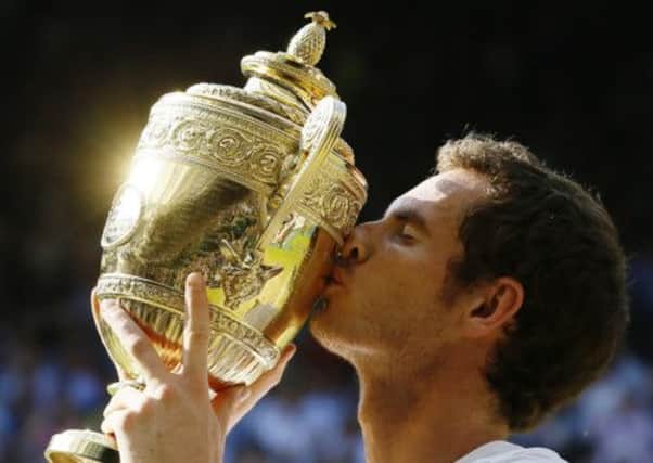 Andy Murray holds the Wimbledon trophy aloft. Picture: AP