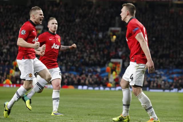 Phil Jones, right, celebrates with teammates after scoring the opening goal against Shakhtar Donetsk. Picture: AP