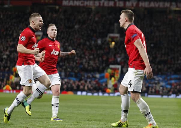 Phil Jones, right, celebrates with teammates after scoring the opening goal against Shakhtar Donetsk. Picture: AP