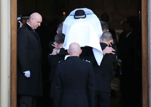 Nelis' coffin is carried by some of her police colleagues. Picture: PA