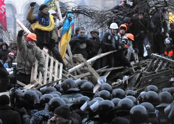 Anti-government protesters defend their barricades in Kiev before the police pulled back. Picture: AFP/Getty