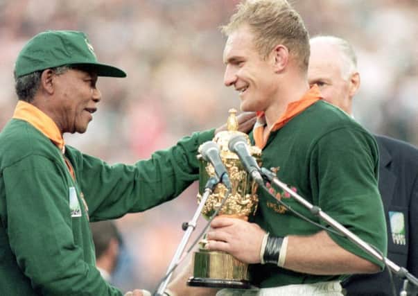 Nelson Mandela presents Francois Pienaar with the Rugby World Cup. Picture: AFP/Getty