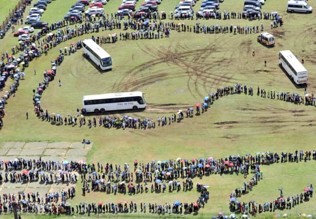 The queue forms a long snake as people wait to pay their last respects in South Africa. Picture: Getty