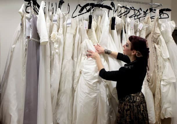 Rachael Forbes checks out wedding dresses in the Stockbridge Red Cross store. Picture: Hemedia