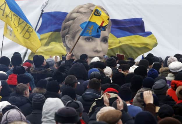 Protesters in Kievs Independence Square hold up a banner Yulia Tymoshenko. Picture: Reuters