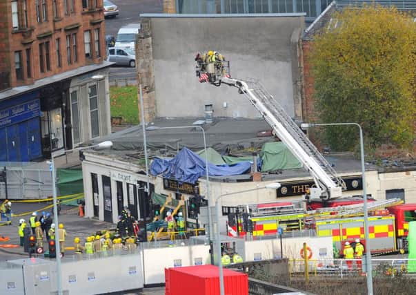 The helicopter is pulled from the wreckage of the Clutha. Picture: Robert Perry