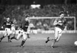 John Robertson chases Gary Stevens in his first match after returning from Newcastle. Picture: Jack Crombie