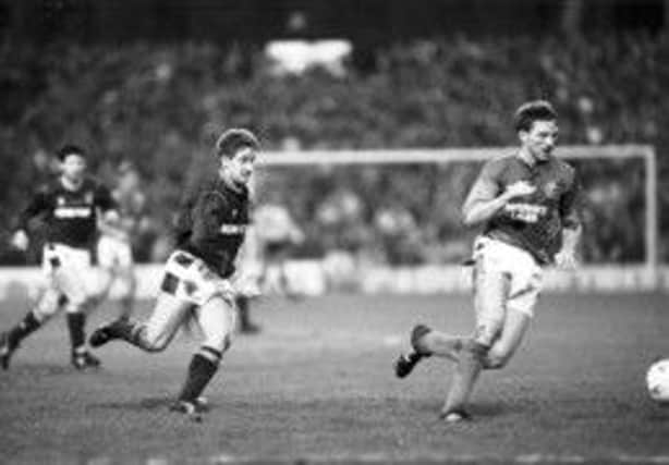 John Robertson chases Gary Stevens in his first match after returning from Newcastle. Picture: Jack Crombie