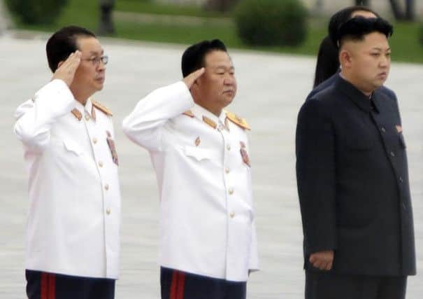 Jang Song Thaek, left, with Kim Jong Un, right, in July this year. Picture: Reuters