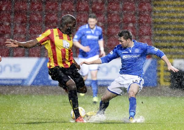Partick's Isaac Osbourne (left) goes for the ball with Gwion Edwards. Picture: SNS