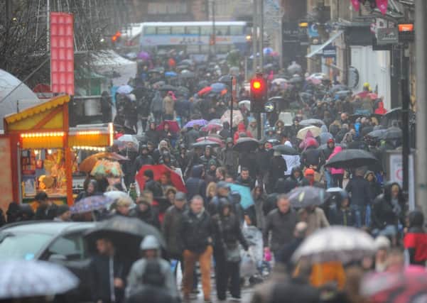 Shoppers in Glasgow brave the poor weather on Saturday. Picture: Robert Perry