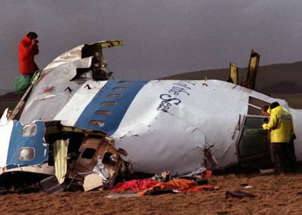 Police and crash investigators examine the wreckage of Pan Am Flight 103 in 1988. Picture: AP Credit
