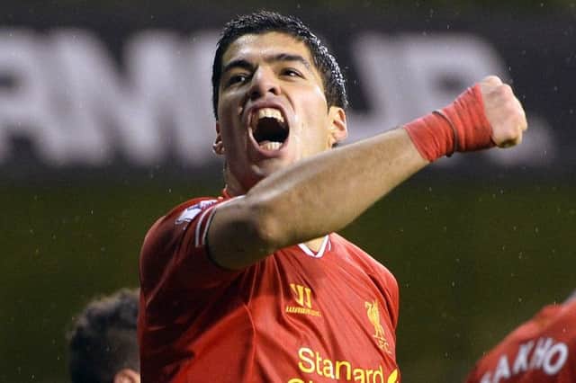 Luis Suarez celebrates after scoring one of his two goals at White Hart Lane yesterday. Picture: Reuters