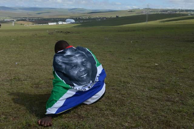 A man sits overlooking the place where Nelson Mandela was laid to rest. Picture: Getty