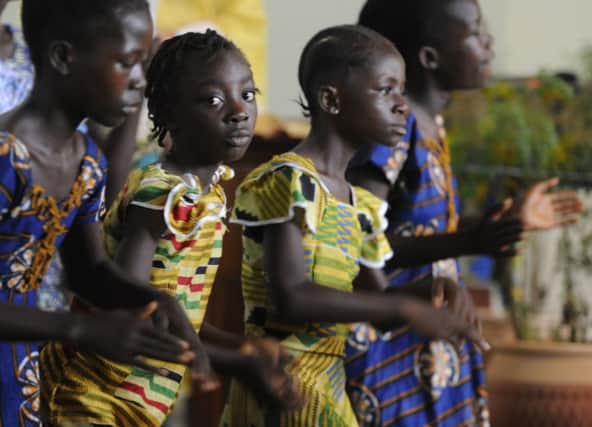Children dance at Sunday mass at St Dominics in Tubmanburg, Western Liberia. Picture: Esme Allen