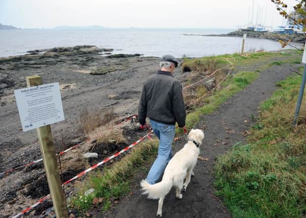 Parts of Dalgety Bay foreshore have been taped off and warning signs erected. Picture: Ian Rutherford
