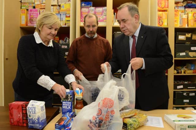 Salmond joins volunteers Gordon Murray and Marina Laing to pack bags for the foodbank. Picture: Neil Hanna