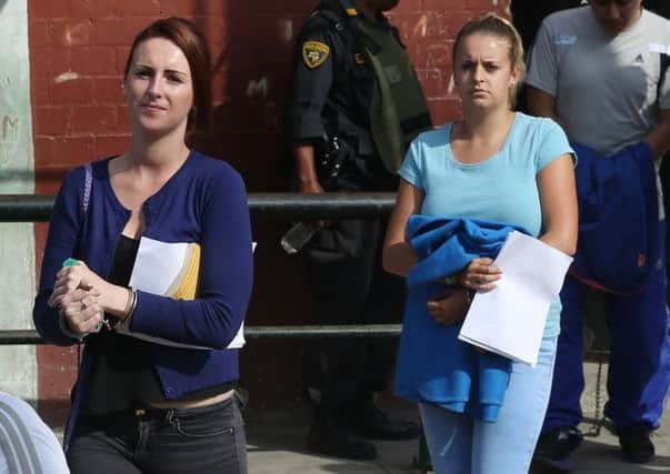 Michaella McCollum left, and Melissa Reid, right, leave the court after being sentenced in Callao, Peru. Picture: AP