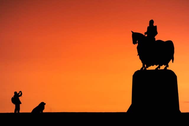 A visitor photographs the statue of Robert the Bruce at Bannockburn. Picture: Ian Rutherford