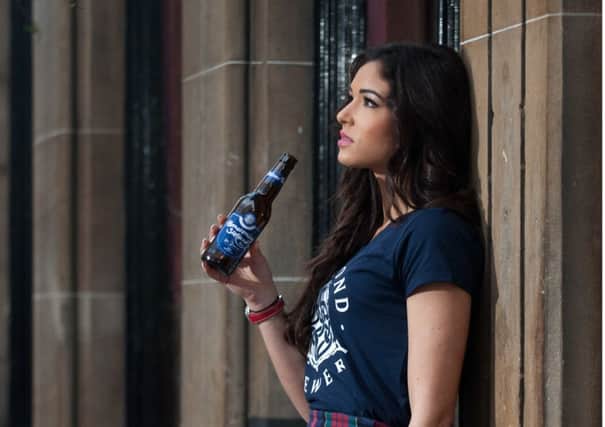 Miss Scotland, Jamey Bowers, raises a glass to mark the first delivery of the beer. Picture: Gareth Easton