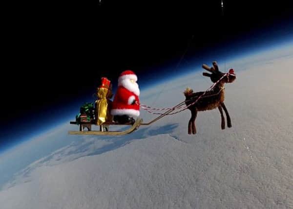 Santa above the Earth. Picture: SWNS/HeMedia