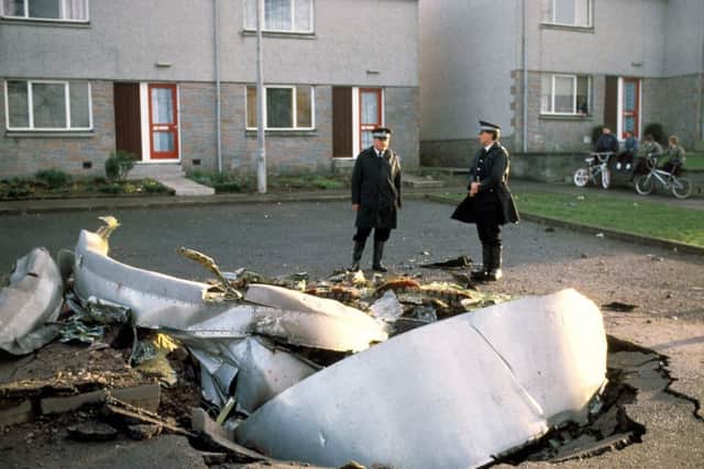 Police officers stand by debris strewn across the town after the explosion. Picture: PA