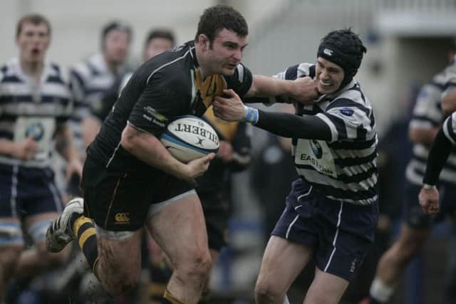 Currie hooker David Cherry holds off a Heriots defender on the way to the try line. Picture: Toby Williams