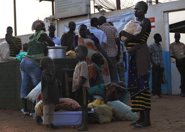 Sudanese wait at the UN compound in Juba yesterday, seeking refuge. Picture: Getty Images