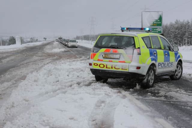 Police stop traffic on the A9 yesterday, after lorries were stuck in snow at Dalwhinnie. Picture: Peter Jolly