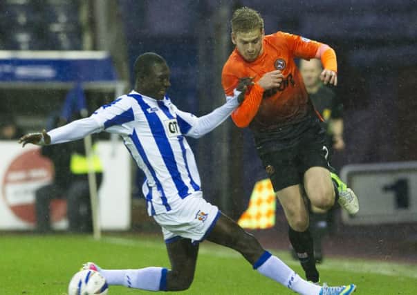 Stuart Armstrong takes on Gabriel Reuben. The Tannadice star has been linked with Celtic. Picture: SNS