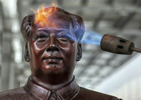 An employee works on a statue of Mao Zedong at a factory in Shaoshan, Maos hometown, in Hunan province. Picture: AP