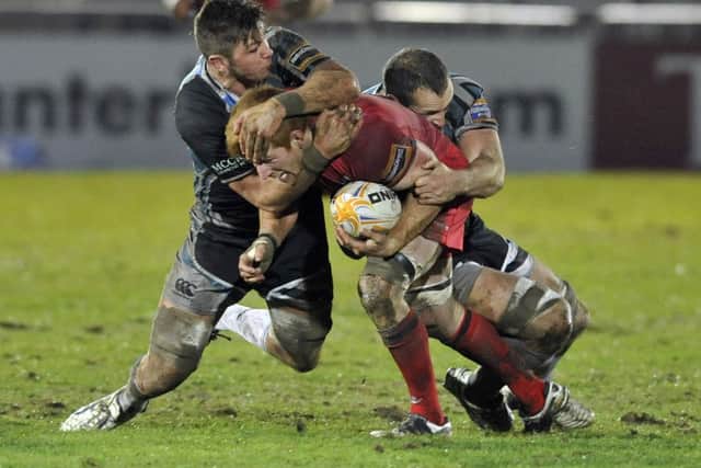 Edinburgh's Roddy Grant tackled by Glasgow defence in last year's 1872 Cup. Picture: TSPL