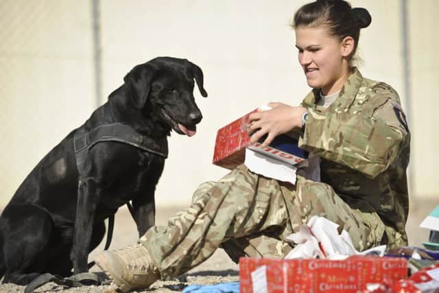 Private Zina Saunders, a dog handler, with Hazel. Picture: PA
