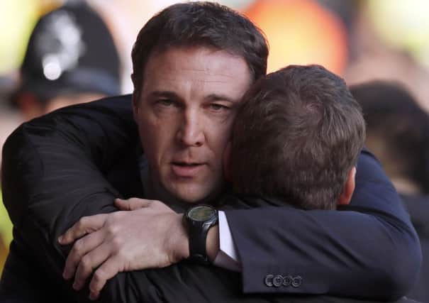 Malky Mackay embraces Liverpool boss Brendan Rodgers prior to Saturdays 3-1 defeat. Picture: Reuters