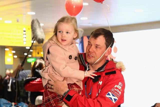 Duncan Slater is embraced by his daughter Lilly. Picture: Getty