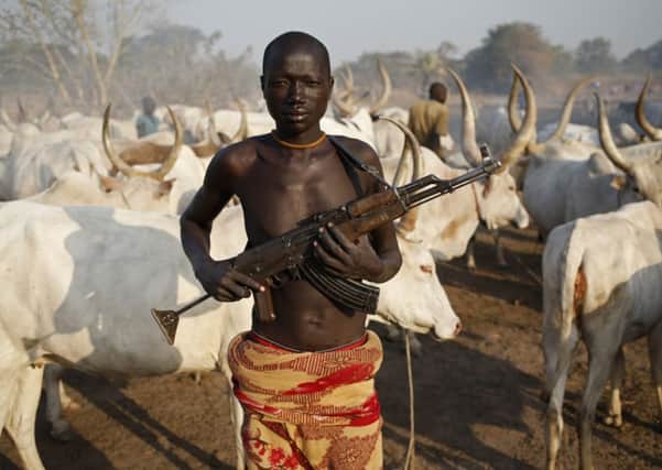 A Dinka herdsman carries an AK-47 against cattle thieves  often from the rival Nuer tribe. Picture: Reuters