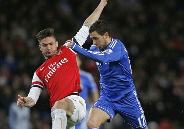Chelseas Eden Hazard, right, and Arsenals Olivier Giroud challenge for the ball. Picture: Getty