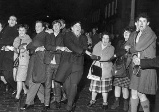 Auld Lang's Syne is sung at Edinburgh's Tron at New Year in 1964. Picture: TSPL