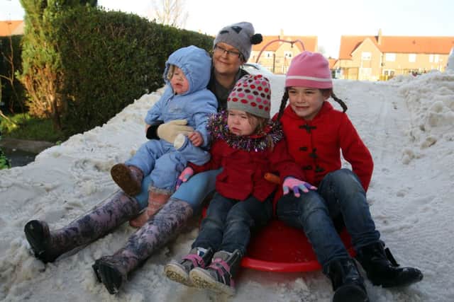 The Kirkton family play in their snow. Picture: PA