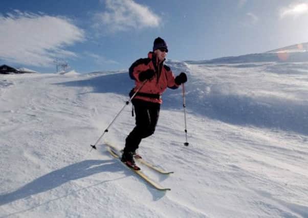 A skiier enjoys the snowfall near near Aviemore. Picture: TSPL