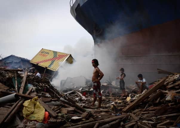 Children among the debris as the clean up continues over Christmas in Tacloban. Picture: Getty