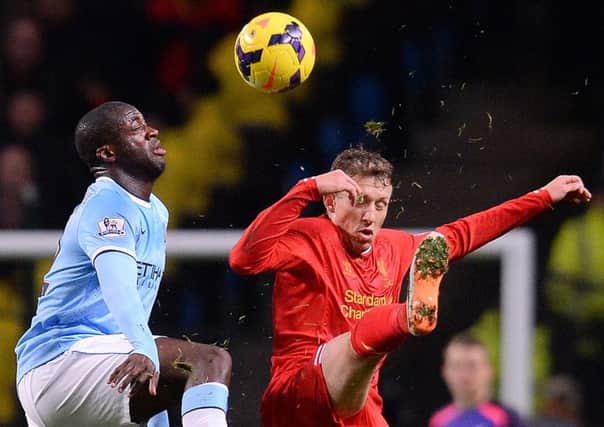 Yaya Toure vies with Lucas Leiva of Liverpool during yesterdays clash at the Etihad Stadium. Picture: AFP/Getty