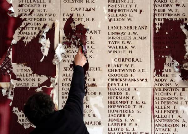 Danny Delplace carries out restoration work to the names on the Menin Gate memorial at Ypres, Belgium. Picture: PA