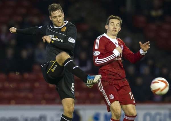 Paul Lawson (left) in action against Aberdeen's Peter Pawlett. Picture: SNS
