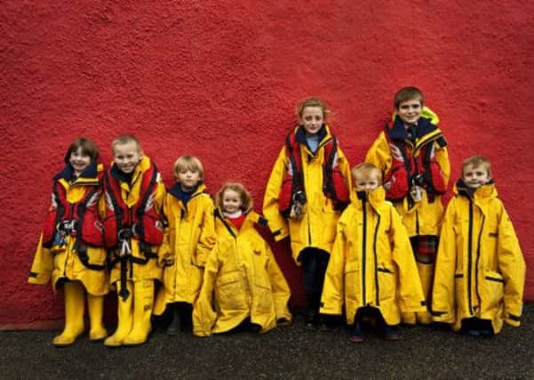 Tobermory children try out their fathers crew kit. Picture: RNLI