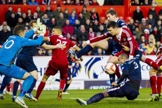 Aberdeen's Ryan Jack causes problems for the Ross County defence. Picture: SNS