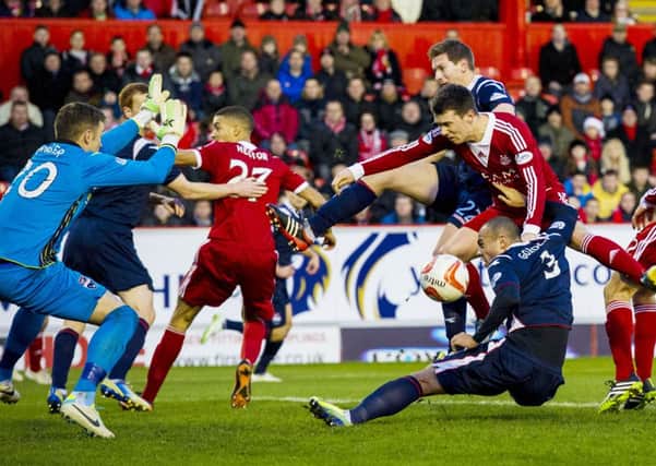 Aberdeen's Ryan Jack causes problems for the Ross County defence. Picture: SNS